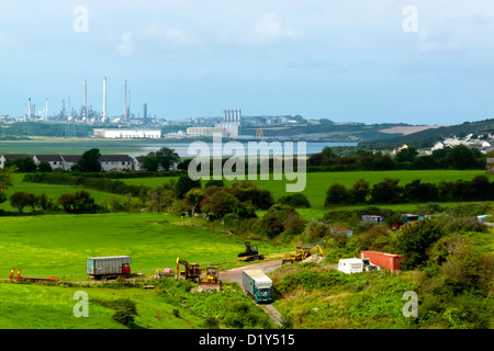 Distant view across fields from Pembroke of Milford Haven oil refinery and LNG gas terminal Pembrokeshire South Wales UK Stock Photo