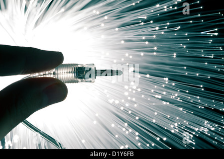 Hand with audio cable and technology background Stock Photo