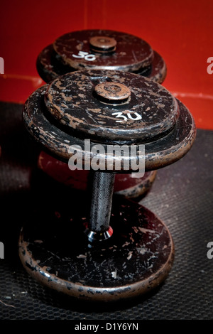 An old but well used set of dumbbells at the gym. Stock Photo