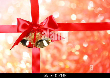 Red Christmas Ribbon with Bells over Christmas Abstract Lights Stock Photo