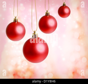 Red Christmas ornaments with pink lights background Stock Photo