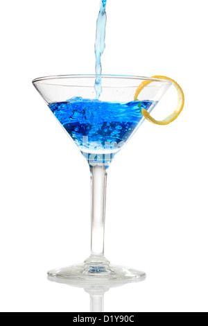 Blue cocktail being poured into a glass on white background Stock Photo