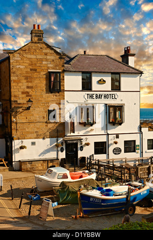 Fishing boats & the Bay Hotel of historic fishing village of Robin Hood's Bay, Near Whitby, North Yorkshire, England. Stock Photo