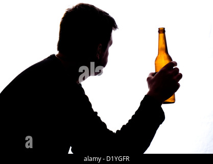 Silhouette of a man with a beer bottle. Strong contrast, graphic style. Isolated on a white background. Stock Photo