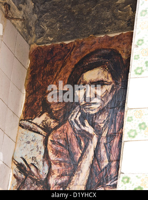 Mural of sad woman with child on wall of deserted abandoned house Lisbon Portugal western Europe Stock Photo