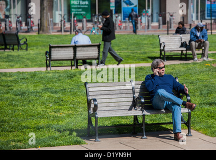 People relaxing in a small park in central Washington DC USA Stock Photo