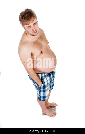 Overweight, fat man weighing himself on scales. Stock Photo