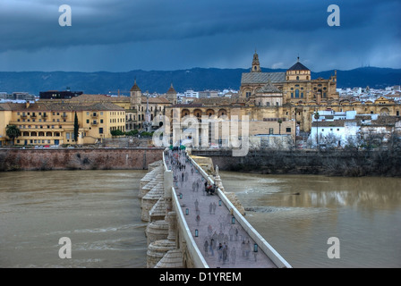 Roman bridge in City of Cordoba, Cordova, under clouded sky, Andalusia, Spain. Stock Photo
