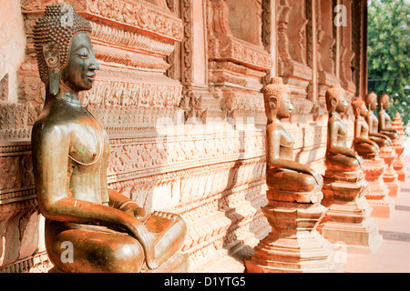 Beautiful bronze statues of Buddha surround the Sim at Haw Pha Kaew in Vientiane, Laos, Indochina. Stock Photo