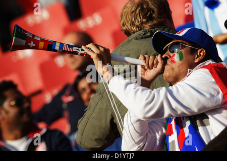 An Italy supporter blows a vuvuzela at the FIFA World Cup Group F match between Italy and Slovakia at Ellis Park Stadium. Stock Photo
