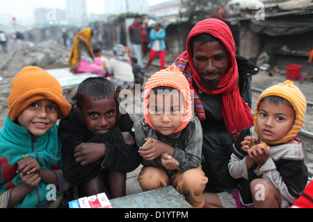 Homeless people in Bangladesh create fire by using discarded wood or plastic to provide some warmth as winter temperatures drop Stock Photo