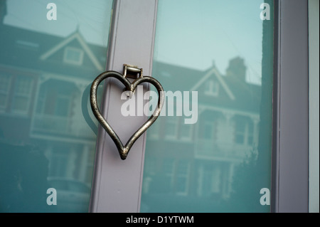 Heart shaped door knocker, glass door, reflections Stock Photo