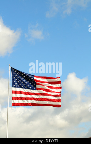 US Flag Stars and Stripes unfurled in a strong breeze red, white and blue. Stock Photo