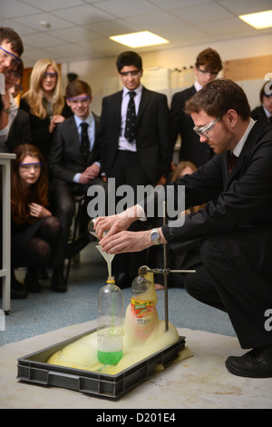 A teacher demonstrates a chemistry experiment during a science lesson at Pates Grammar School in Cheltenham, Gloucestershire UK Stock Photo