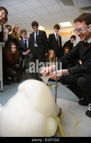 A teacher demonstrates a chemistry experiment during a science lesson at Pates Grammar School in Cheltenham, Gloucestershire UK Stock Photo