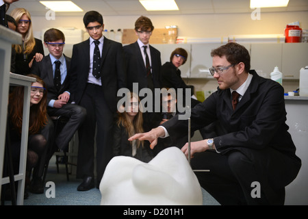 A teacher demonstrates a chemistry experiment during a science lesson at Pates Grammar School in Cheltenham, Gloucestershire UK Stock Photo