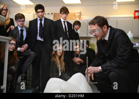 A teacher demonstrates a chemistry experiment during a science lesson at Pates Grammar School in Cheltenham, Gloucestershire UK Stock Photo
