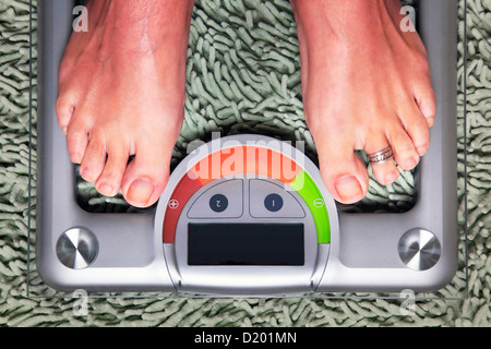 Bathroom scales isolated against green carpet Stock Photo