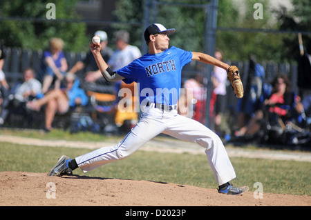 Baseball Pitcher pitches ball in high school game., USA. Stock Photo