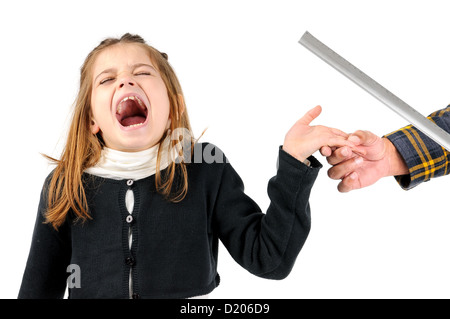 Young girl being physically punished by teacher with a ruler Stock Photo