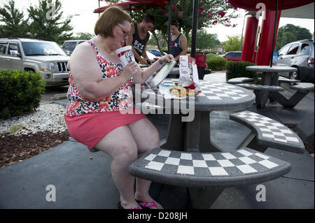 Aug. 2, 2012 - Marietta, GA - Overweight middle-aged woman eats high-fat lunch of cheeseburger, friends and soft drink at fast food restaurant near Atlanta. (Credit Image: © Robin Nelson/ZUMAPRESS.com) Stock Photo