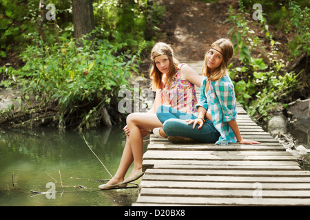 Young girls on the wooden bridge Stock Photo