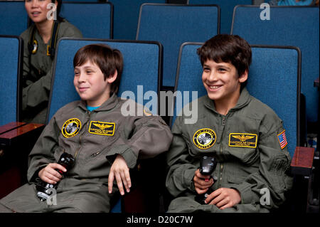 Jan. 09, 2013 - Anaheim, California, U.S. - Conrad Holzman, 11, (left) and Kian Babaian, 11, watch as their flight instructor gives them a crash course in what they're about to encounter at Flightdeck, a flight simulation center near Disneyland which features nine fighter jet simulators and one commercial Boeing 737-700 simulator.(Credit Image: © Brian Cahn/ZUMAPRESS.com) Stock Photo