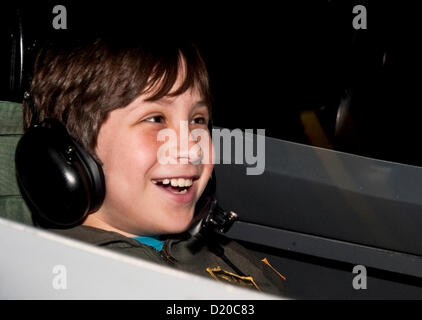 Jan. 09, 2013 - Anaheim, California, U.S. - Conrad Holzman, 11, laughs during air-to-air combat against his friend in the adjacent simulator during their alloted 45 minutes at Flightdeck, a flight simulation center near Disneyland which features nine fighter jet simulators and one commercial Boeing 737-700 simulator.(Credit Image: © Brian Cahn/ZUMAPRESS.com) Stock Photo