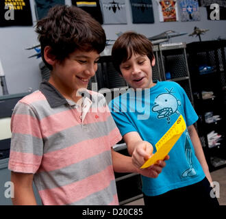 Jan. 09, 2013 - Anaheim, California, U.S. - Conrad Holzman, 11, (right) and Kian Babaian, 11, share a laugh about their scorecards after 45 minutes of flight time at Flightdeck, a flight simulation center near Disneyland which features nine fighter jet simulators and one commercial Boeing 737-700 simulator.(Credit Image: © Brian Cahn/ZUMAPRESS.com) Stock Photo