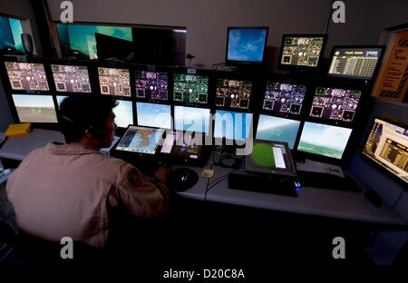 Jan. 09, 2013 - Anaheim, California, U.S. - Flight instructor Simon Kim keeps things humming in the air traffic control center at Flightdeck, a flight simulation center near Disneyland which features nine fighter jet simulators and one commercial Boeing 737-700 simulator.(Credit Image: © Brian Cahn/ZUMAPRESS.com) Stock Photo