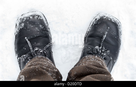 Black leather men's shoes with snow Stock Photo