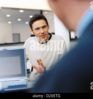 Business meeting - Young man presenting his ideas to colleagues License free except ads and billboards Stock Photo