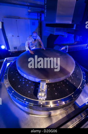 Technician Majid Salimi works on the world's biggest optical machine at the technology campus in Teisnach, Germany, 09 January 2013. The machine is supposed to produce in series mirrors for telescopes with diametres of up to two metres for space research. Photo: ARMIN WEIGEL Stock Photo