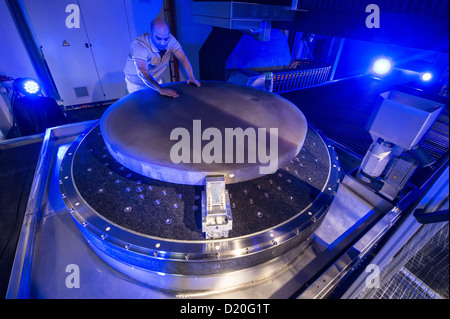Technician Majid Salimi works on the world's biggest optical machine at the technology campus in Teisnach, Germany, 09 January 2013. The machine is supposed to produce in series mirrors for telescopes with diametres of up to two metres for space research. Photo: ARMIN WEIGEL Stock Photo