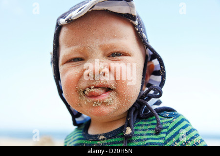 Young boy covered in sand on his face, playing on the beach, Baltic Sea, MR, Bansin, Island Usedom, Mecklenburg-West Pomerania, Stock Photo