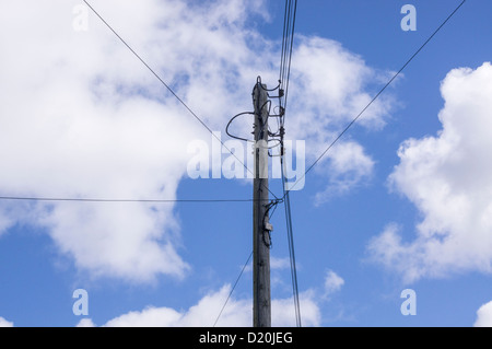 overhead Electricity cables carried on a pole in a village Stock Photo