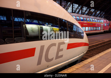 ICE (Intercity Expess) train along side an RE (Regional Express) double-decker passenger train, Cologne, Germany. Stock Photo