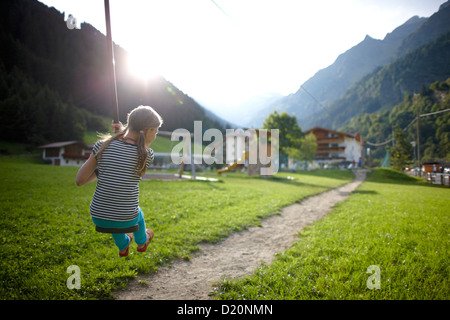 Girl playing on the zip line, outdoor area of Hotel Feuerstein, Pflersch, Gossensass, South Tyrol, Italy Stock Photo