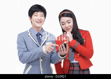 a female and male students using a smartphone Stock Photo
