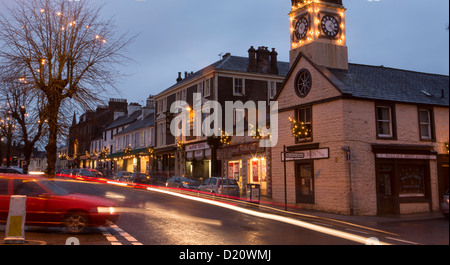 Moffat town centre Christmas lights decorations along the shops and in the trees on High Street as well as light trails from car Stock Photo