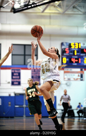 Basketball player finishing off a drive to the hoop during a high school game. USA Stock Photo