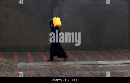 Jan. 10, 2013 - Gaza City, Gaza Strip - A Palestinian bedouin collects water water as a storm hits the eastern Mediterranean coast with heavy rains and flooding forecast in Israel and the Palestinian territories for the next couple of days. (Credit Image: © Ashraf Amra/APA Images/ZUMAPRESS.com) Stock Photo