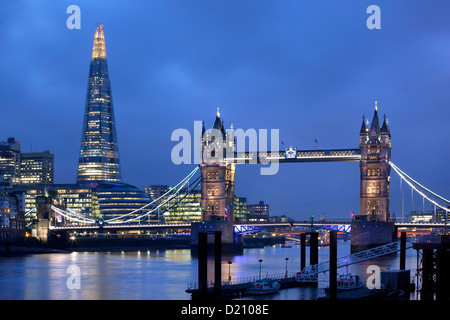 View along river Thames with Tower Bridge and new Shard Building at night, London, England, Europe. Stock Photo