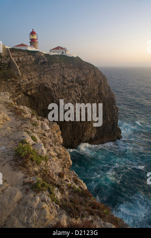 Lighthouse on high cliffs above ocean in evening mood, Cabo de Sao Vicente, Algarve, Portugal, Europe Stock Photo