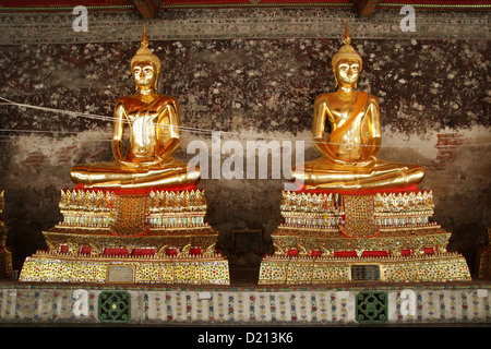 Golden Buddhas in Wat Suthat temple in Bangkok , Thailand Stock Photo