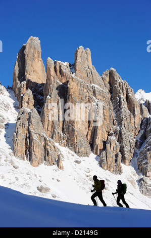 Young woman and young man ascending with crosscountry skis to Corno d'Angolo, rock faces in background, Corno d'Angolo, Cortina, Stock Photo