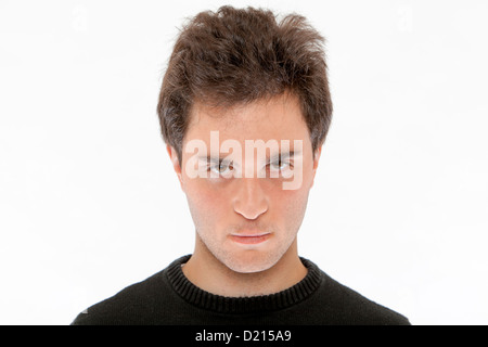 Portrait of a serious and handsome young man against a white background. Stock Photo