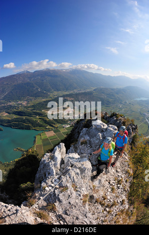 Young woman and young man climbing fixed rope route Rino Pisetta, Lago die Toblino, Sarche, Calavino, Trentino, Trentino-Alto Ad Stock Photo