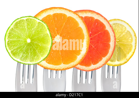 lime, orange, grapefruit, lemon citrus fruit on forks isolated against white Stock Photo