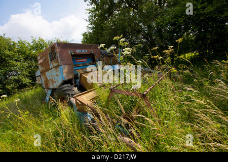 Abandoned Farm machinery is left to rust in overgrown fields near Droitwich, Worcestershire Stock Photo